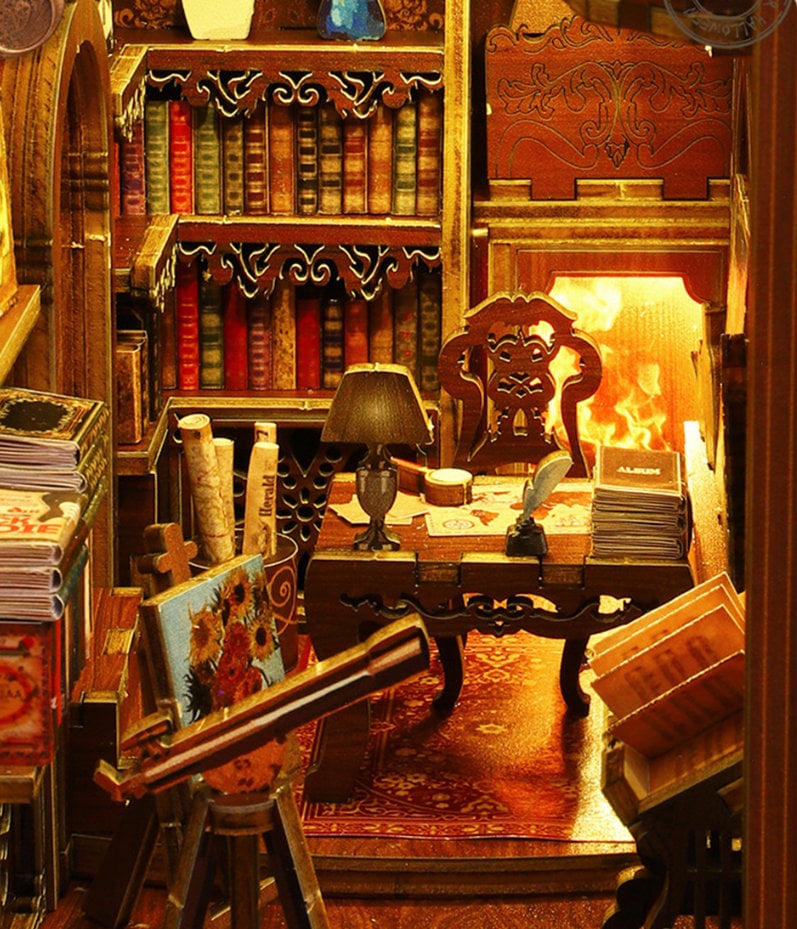May include: A miniature wooden dollhouse room with a fireplace, a bookshelf filled with books, a wooden chair, a desk with a lamp, a telescope, and a painting on an easel. The room is decorated with a rug and a wooden floor.