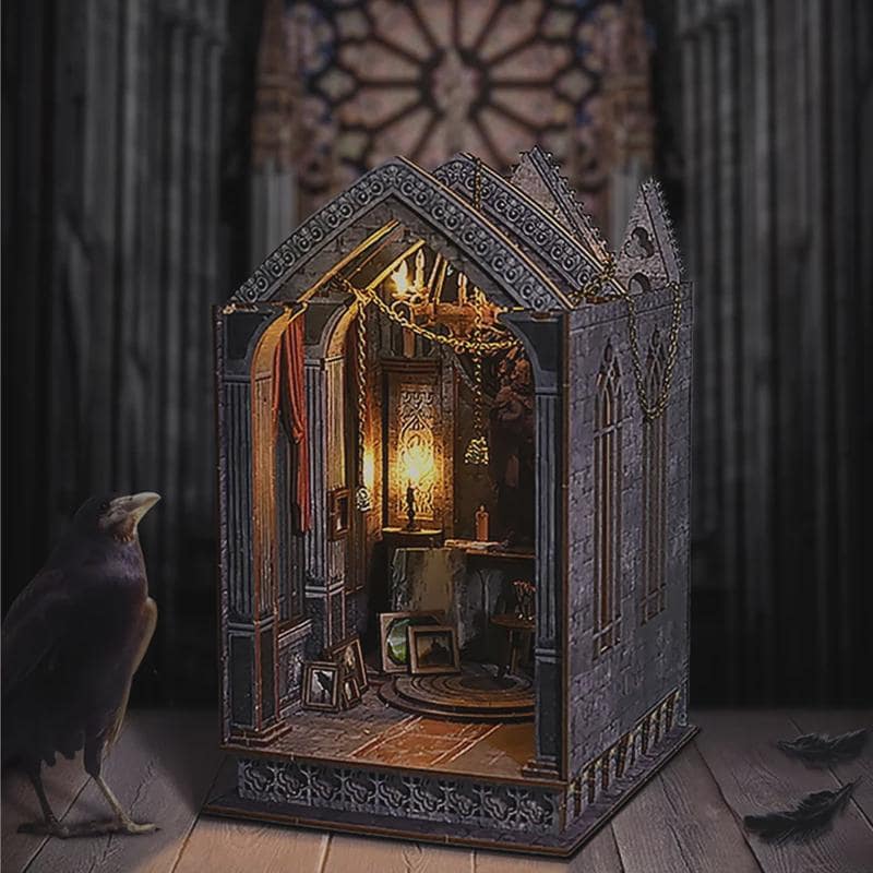 May include: A miniature gothic-style dollhouse with intricate architectural details, including arched windows and decorative trim. The interior is illuminated, showcasing a detailed room with furniture and artwork. A raven stands in the foreground.