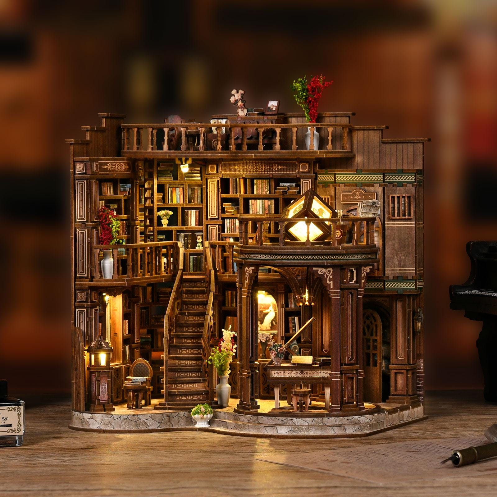 May include: A detailed wooden miniature library with multiple levels, bookshelves, and a staircase. The model features warm lighting, decorative vases, and a small piano. The overall design is intricate, with a focus on architectural detail and a cozy atmosphere.