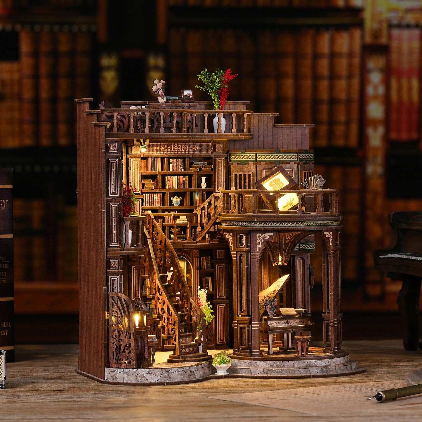 May include: A detailed wooden miniature of a library with multiple levels, stairs, and a piano. The model features intricate carvings, bookshelves filled with tiny books, and warm interior lighting. Decorative flowers and plants add color to the scene.