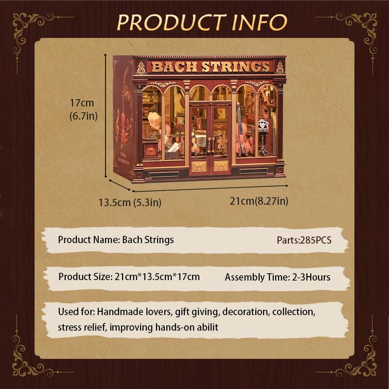 May include: A miniature wooden model of a shop called "Bach Strings", with dimensions of 21 inches long, 5.3 inches wide, and 6.7 inches tall. The model features a detailed facade with windows and doors, and includes the text "Bach Strings".