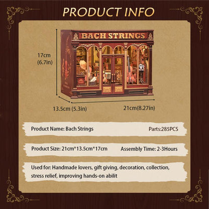 May include: A miniature wooden model of a shop called "Bach Strings", with dimensions of 21 inches long, 5.3 inches wide, and 6.7 inches tall. The model features a detailed facade with windows and doors, and includes the text "Bach Strings".