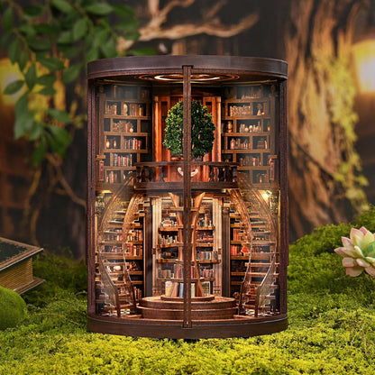 May include: A miniature wooden bookshelf diorama with a spiral staircase and a small tree. The interior is filled with tiny books and warm lighting. The exterior is a dark brown color, and the diorama is set on a bed of green moss.